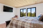 Master bedroom with king bed and stunning forest views